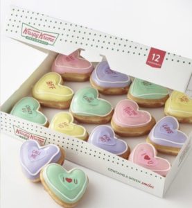 Krispy Kreme doughnuts in the shape of hearts with pastel colors for Valentine's Day