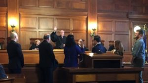 supreme court: people being sworn in in a court room
