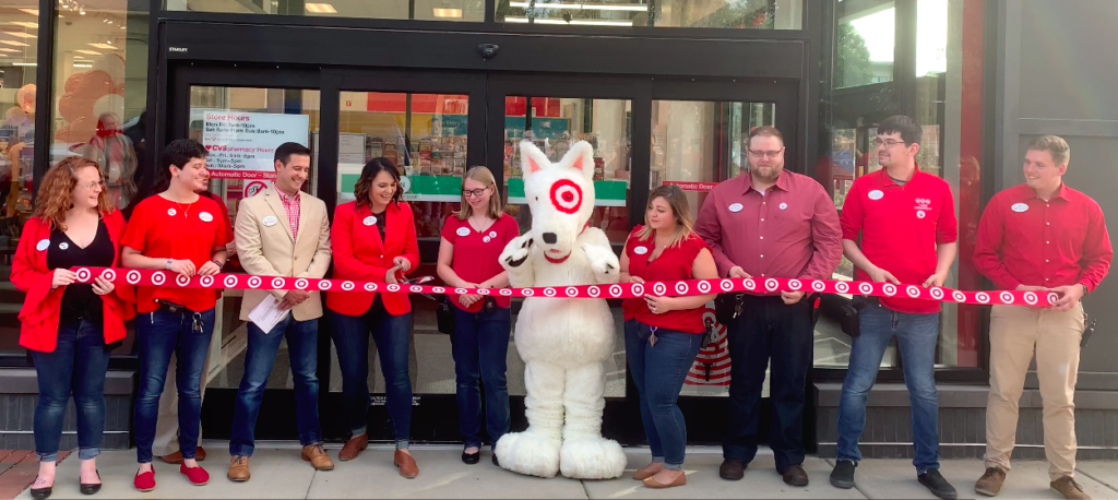 group of people cutting a ribbon with target symbol all over