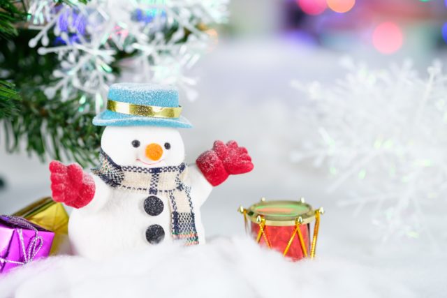 snow man with a red gloves and a drum