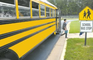 weather make-up days: yellow school bus with a kid getting off