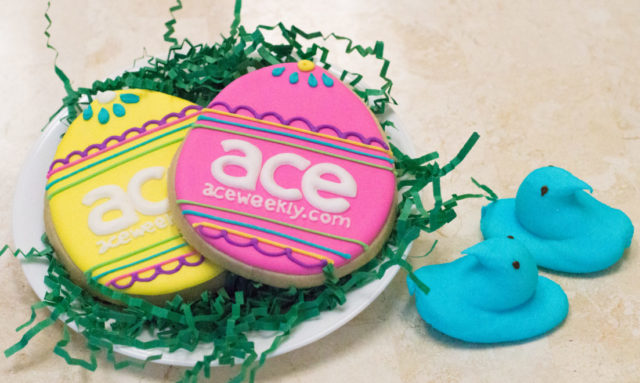 egg shaped cookies with colorful icing that say ace on it