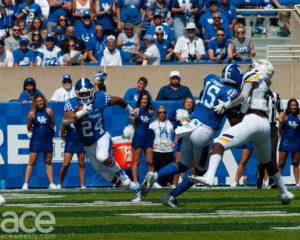Kentucky football players on the field playing against Toledo